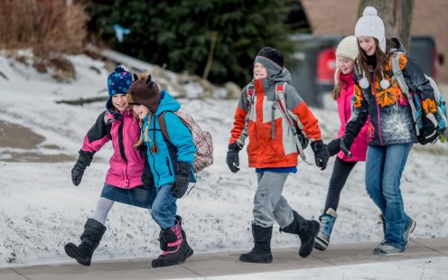Kids walking to school together in winter