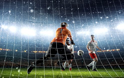 Intense soccer moment in front of the goal on the professional soccer stadium while it's snowing. Stadium and crowd are made in 3D.